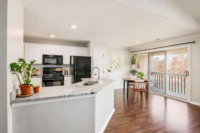 kitchen with white cabinetry, dark wood-type flooring, sink, and black appliances