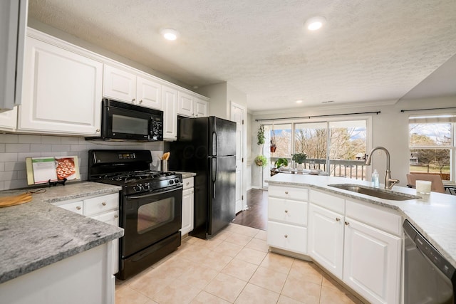 kitchen with white cabinets, sink, and black appliances