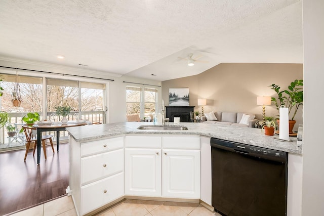 kitchen featuring sink, white cabinetry, light stone counters, black dishwasher, and kitchen peninsula