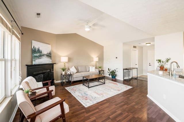 living room featuring sink, vaulted ceiling, dark hardwood / wood-style floors, and ceiling fan