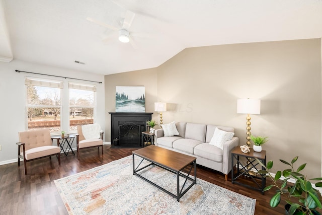 living room with ceiling fan, dark hardwood / wood-style flooring, and vaulted ceiling