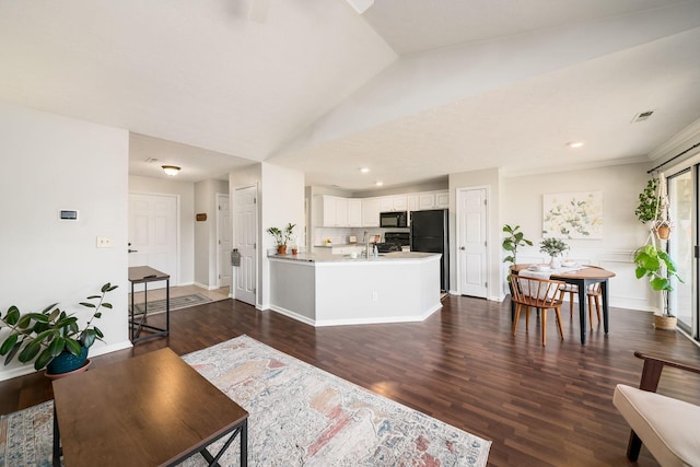 living room with dark hardwood / wood-style flooring and lofted ceiling