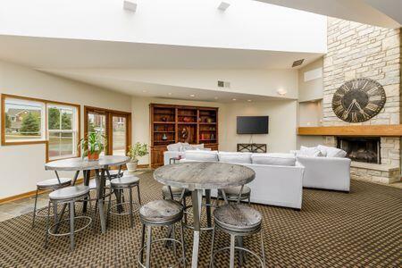 dining room with a fireplace and vaulted ceiling