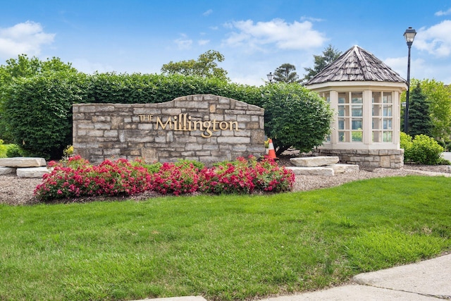 community sign featuring a lawn