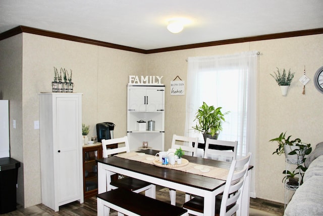 dining room with dark wood-type flooring and ornamental molding