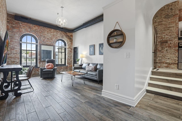 interior space featuring brick wall and a chandelier