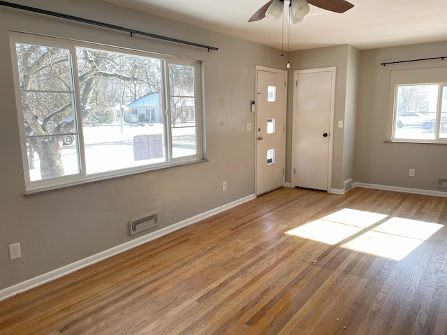 foyer with ceiling fan and light wood-type flooring