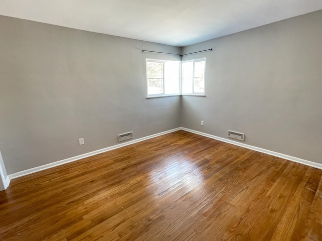 unfurnished room featuring hardwood / wood-style floors