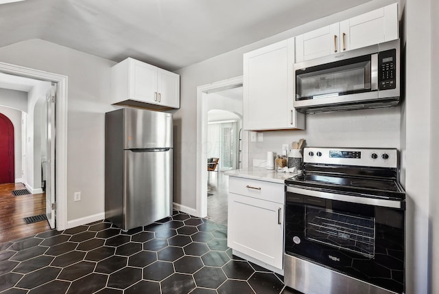 kitchen featuring light stone countertops, white cabinetry, and stainless steel appliances