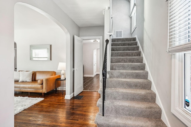 stairs featuring wood-type flooring