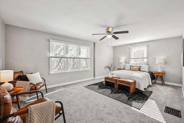 bedroom with ceiling fan, multiple windows, and carpet floors