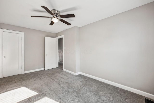 unfurnished bedroom with ceiling fan and carpet