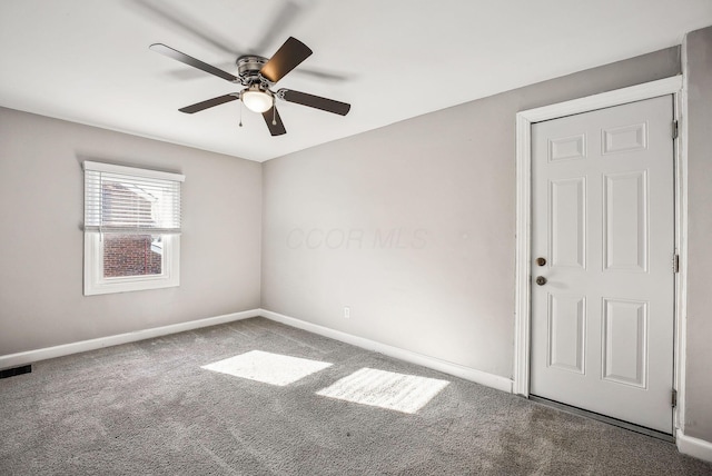 carpeted empty room featuring ceiling fan