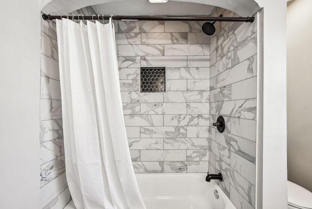 bathroom with toilet and shower / tub combo