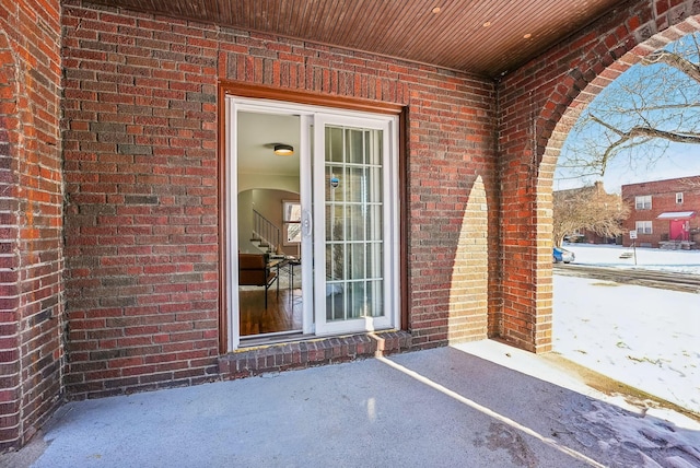 view of snow covered property entrance