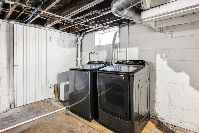 clothes washing area with washing machine and clothes dryer