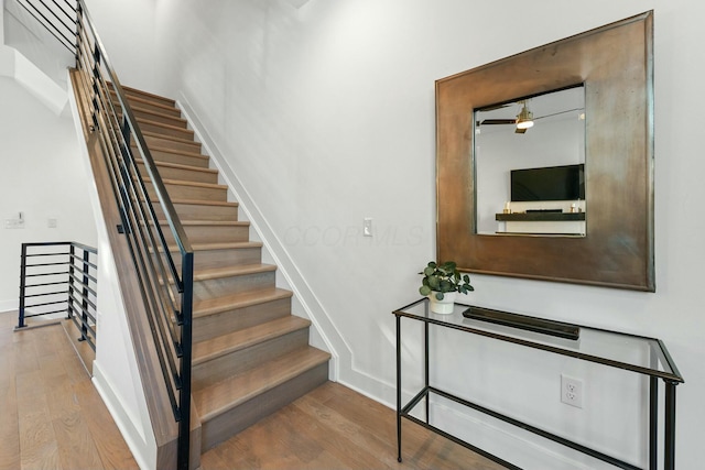 stairs with hardwood / wood-style flooring