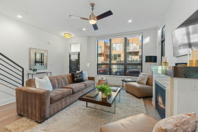 living room featuring ceiling fan and light wood-type flooring