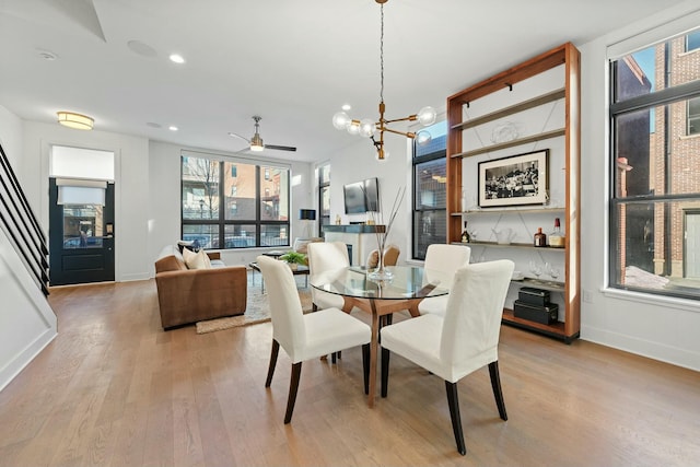 dining room featuring an inviting chandelier, plenty of natural light, and light hardwood / wood-style floors