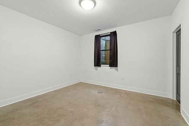 empty room with concrete flooring