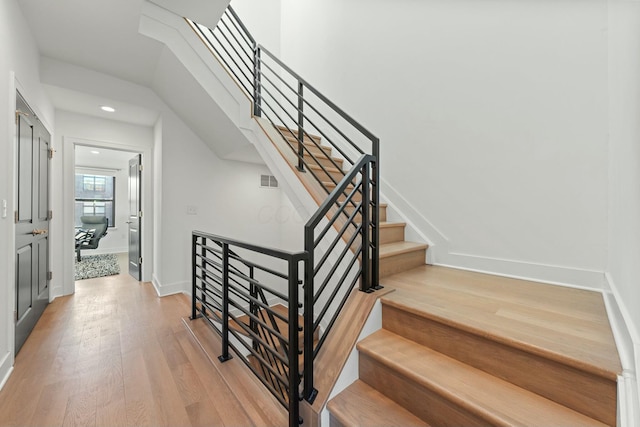 stairway featuring wood-type flooring