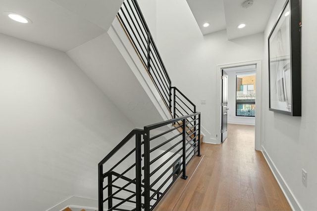 stairs featuring hardwood / wood-style flooring