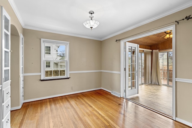 spare room with visible vents, baseboards, and hardwood / wood-style flooring