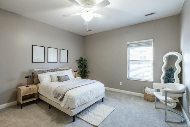 bedroom with ceiling fan and light carpet