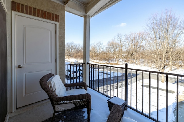 view of snow covered back of property