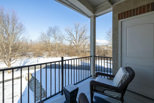 view of snow covered back of property