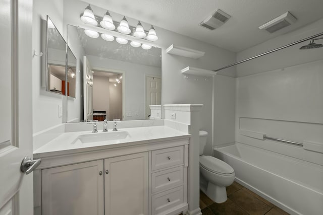 full bathroom with shower / tub combination, vanity, a textured ceiling, toilet, and tile patterned floors