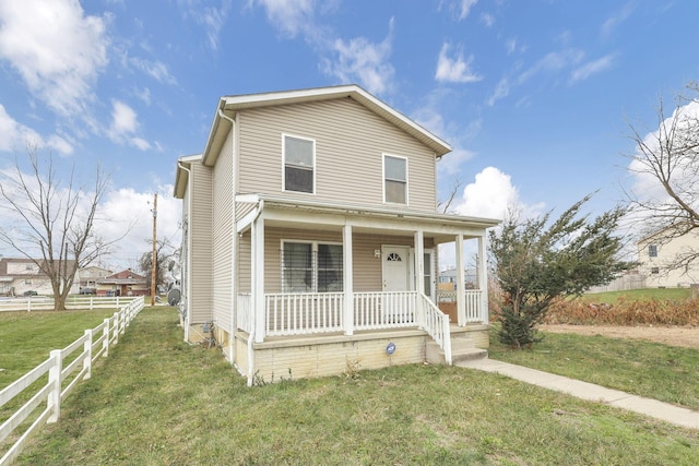 view of front of house featuring a front yard and a porch