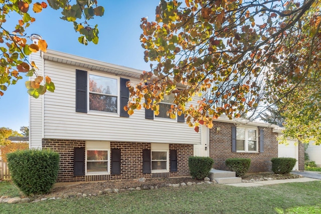 tri-level home with a front yard