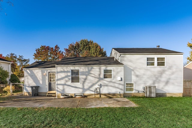 rear view of property with a patio, a yard, and cooling unit