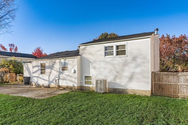 rear view of house featuring a yard, a patio area, and central air condition unit