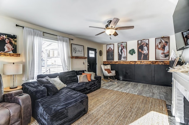 living room with hardwood / wood-style flooring and ceiling fan