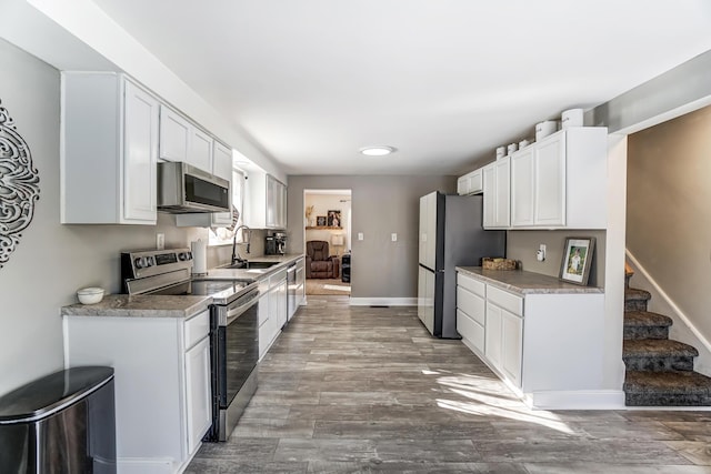 kitchen with sink, white cabinets, and stainless steel appliances