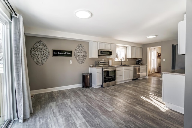 kitchen with white cabinets, dark wood-type flooring, sink, and stainless steel appliances