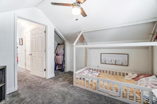 bedroom with ceiling fan, lofted ceiling, and dark colored carpet