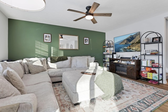 living room featuring ceiling fan and light hardwood / wood-style flooring