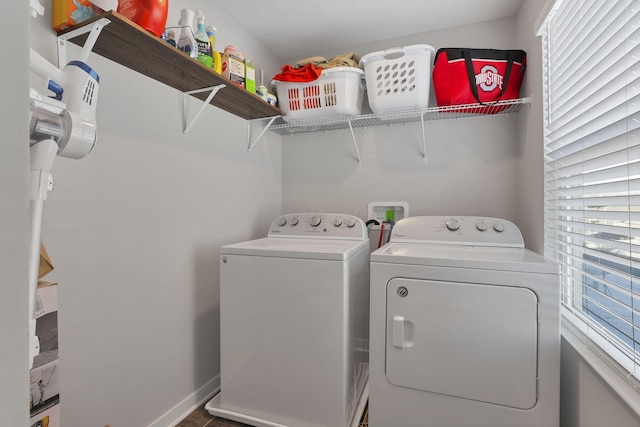 clothes washing area featuring washer and dryer