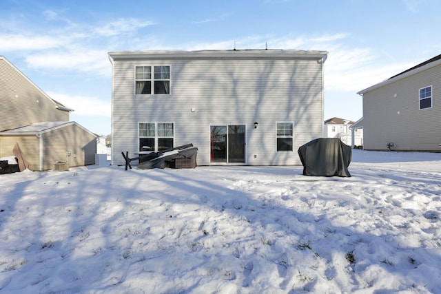 view of snow covered rear of property