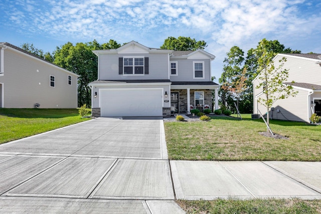 view of property with a front yard, covered porch, and a garage