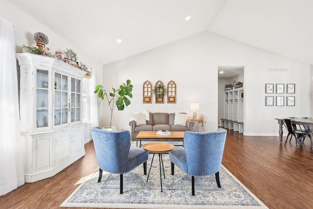 living room featuring vaulted ceiling and dark hardwood / wood-style flooring