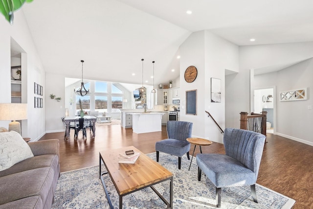 living room with dark wood-type flooring, sink, and high vaulted ceiling