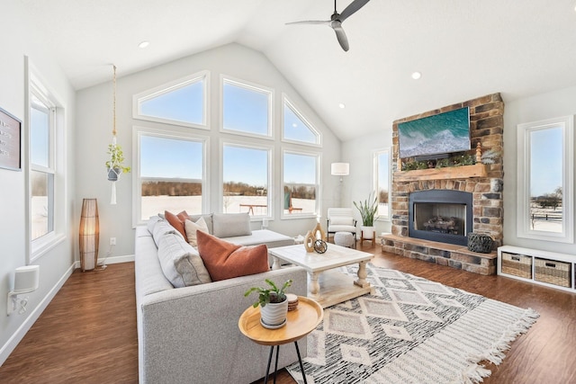 living room with a fireplace, high vaulted ceiling, dark hardwood / wood-style floors, and ceiling fan