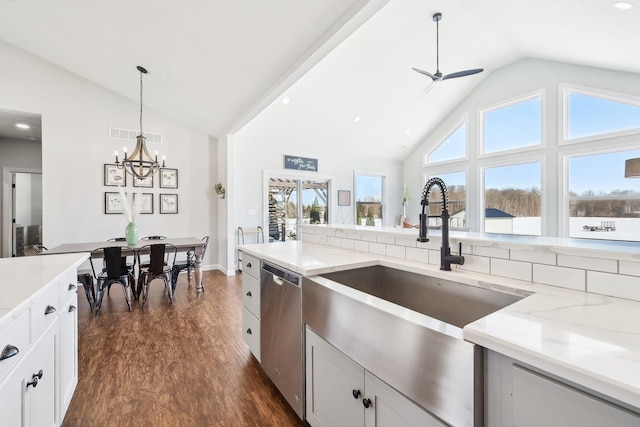 kitchen with white cabinetry, stainless steel dishwasher, dark hardwood / wood-style flooring, and light stone countertops