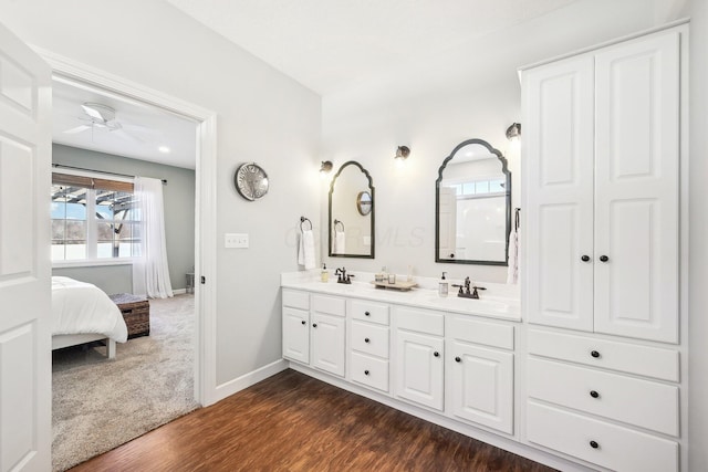 bathroom featuring ceiling fan, wood-type flooring, and vanity