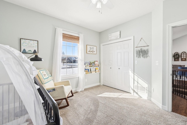 interior space featuring light carpet and ceiling fan