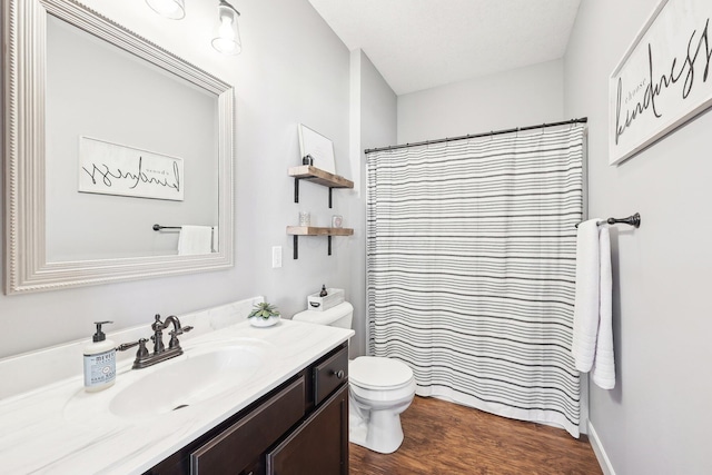 bathroom featuring hardwood / wood-style flooring, a shower with shower curtain, vanity, a textured ceiling, and toilet